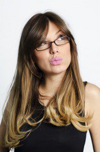 Portrait of doubtful looking beautiful young brunette.